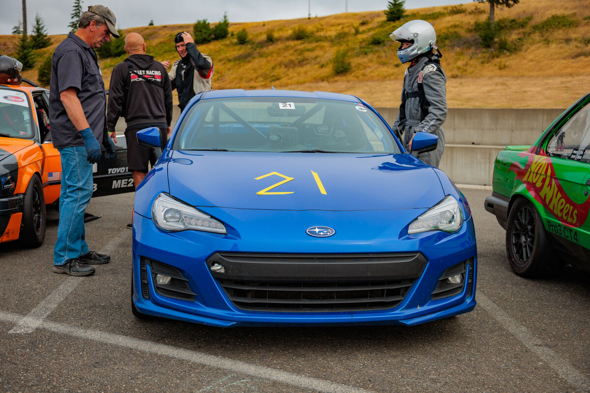 Pro86 race car and drivers on grid